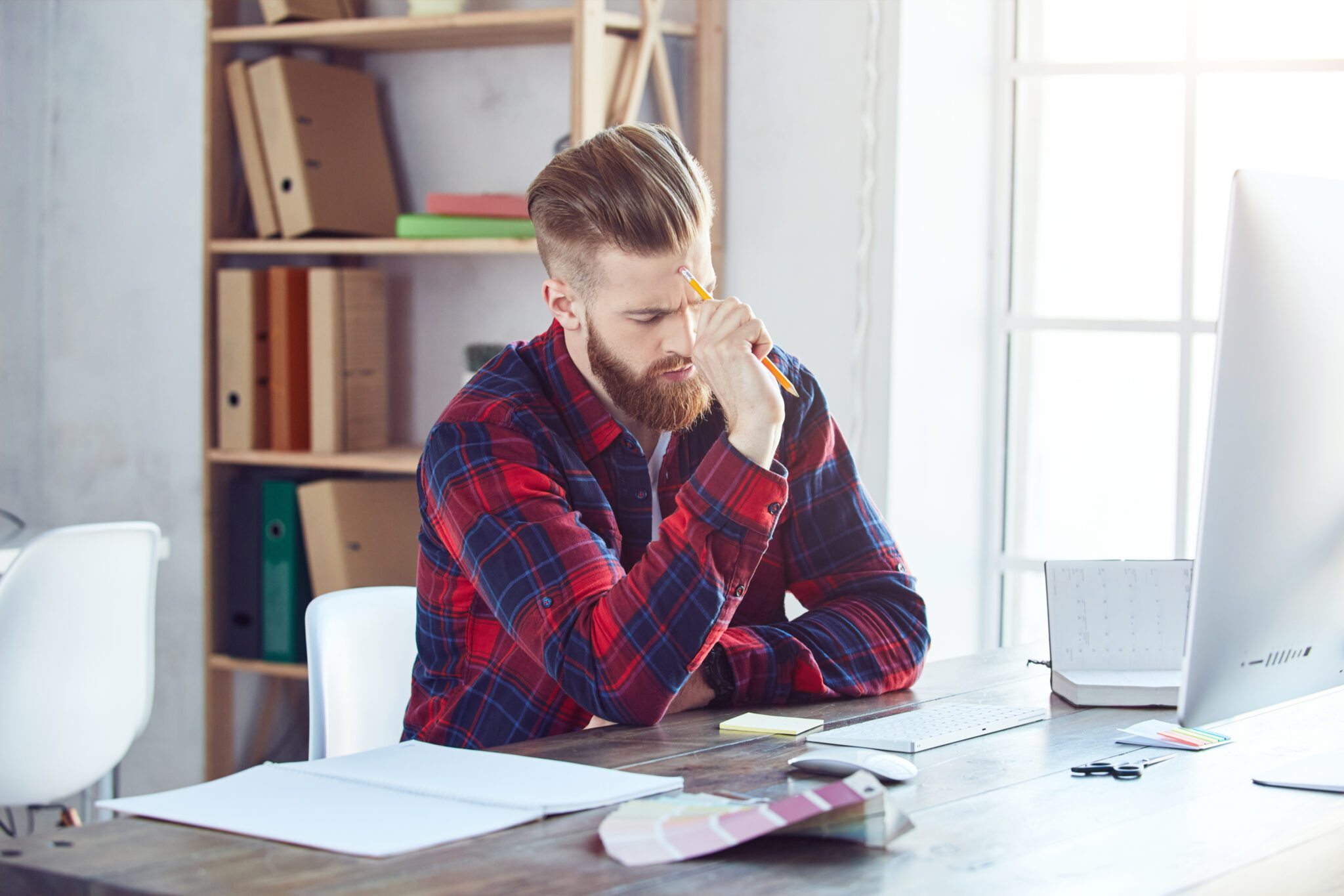 Young man thinking about a new project in the workplace